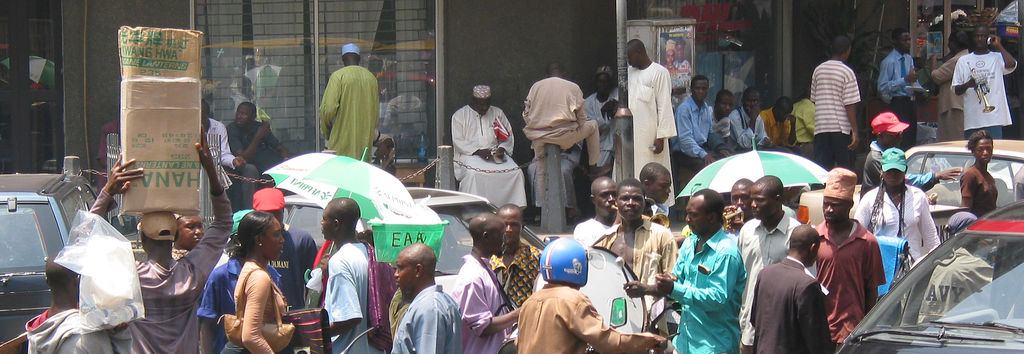 Crowded Lagos market under colourful umbrellas, photographed in 2005